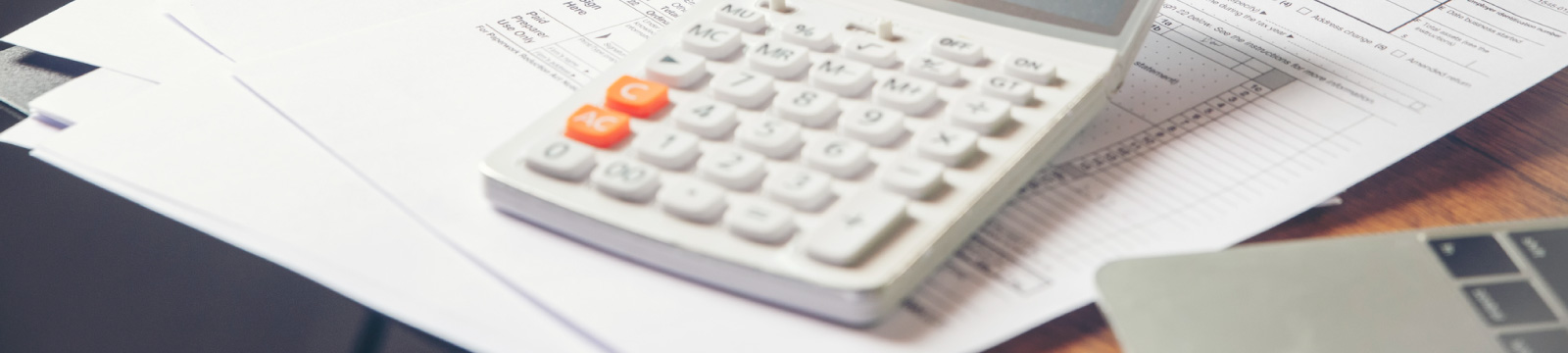 A calculator on a desk with papers