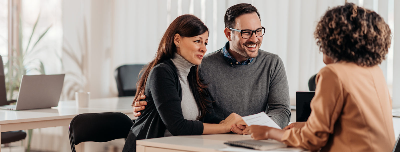 Couple sitting at desk for a meeting