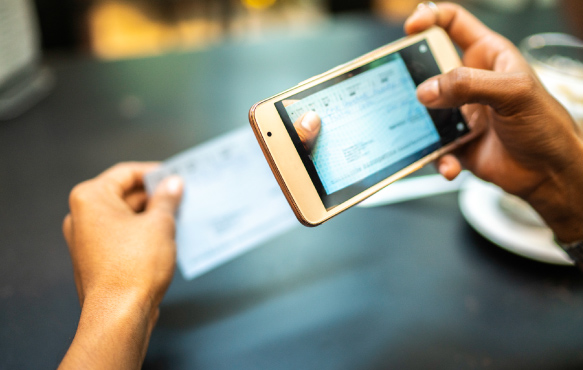 Person using their mobile phone to deposit a check